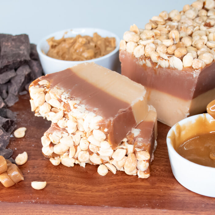 Our Snickers Fudge layers silky smooth peanut butter fudge over rich Belgian chocolate, topped with gooey caramel and blanketed with lightly salted peanuts. Every bite delivers the perfect harmony of sweet, salty, creamy, and crunchy textures. It’s an irresistible combination inspired by a classic favorite—but don't be fooled, our Snickers Fudge is truly in a league of its own.