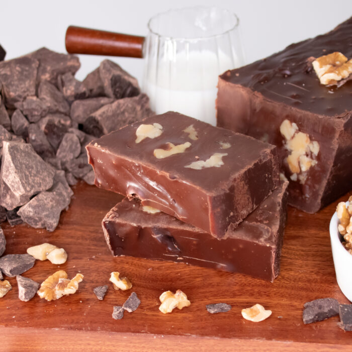 Vegan Chocolate Walnut Fudge, Rich, creamy, and completely dairy-free, our Vegan Chocolate Walnut Fudge is handcrafted with Belgian chocolate, almond milk, and vegan butter for a smooth, decadent treat. Generous pieces of crunchy walnuts are found throughout, adding a balanced texture to every bite. Approved by our dairy-free and dairy-loving customers, this classic combination delivers quality that's sure to become a favorite no matter who you're sharing with.